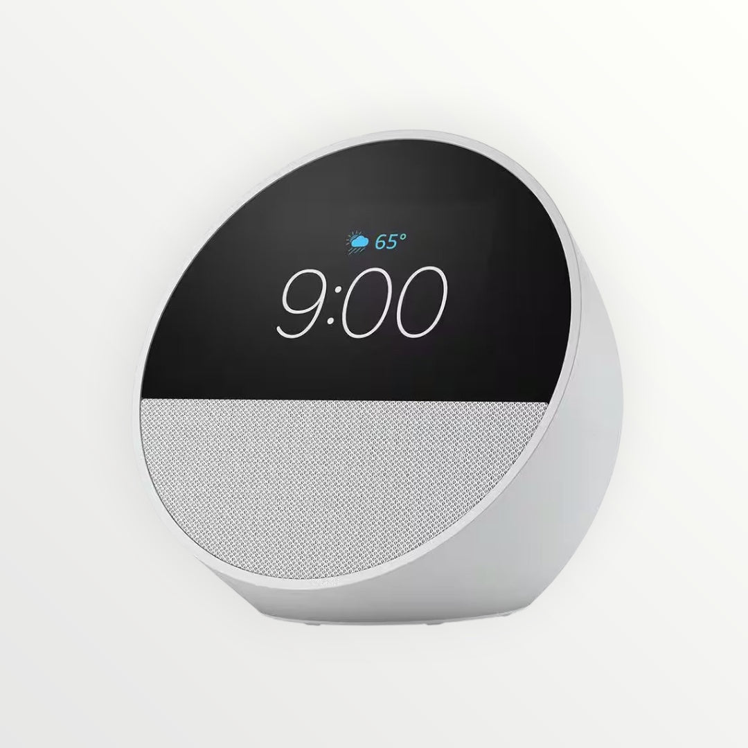 Hostecno Echo Spot smart alarm clock in glacier white with a 2.8-inch display showing 9:00 and weather.